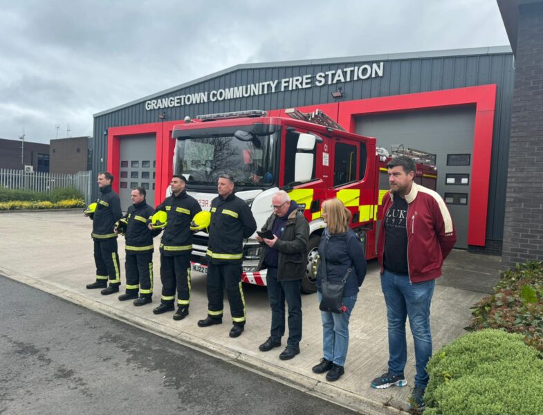 firefighters lined up outside grangetown fire station.