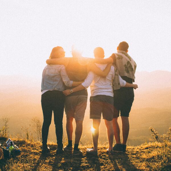 back of a group of people looking at sunset