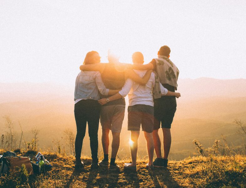 back of a group of people looking at sunset