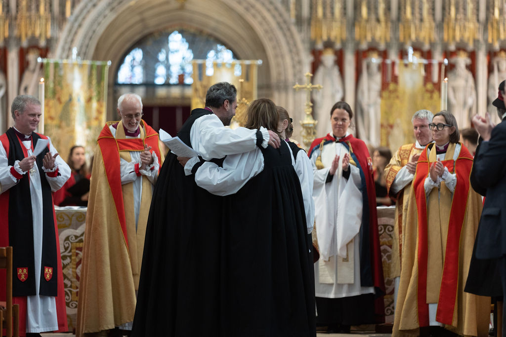 the two new bishops hugging