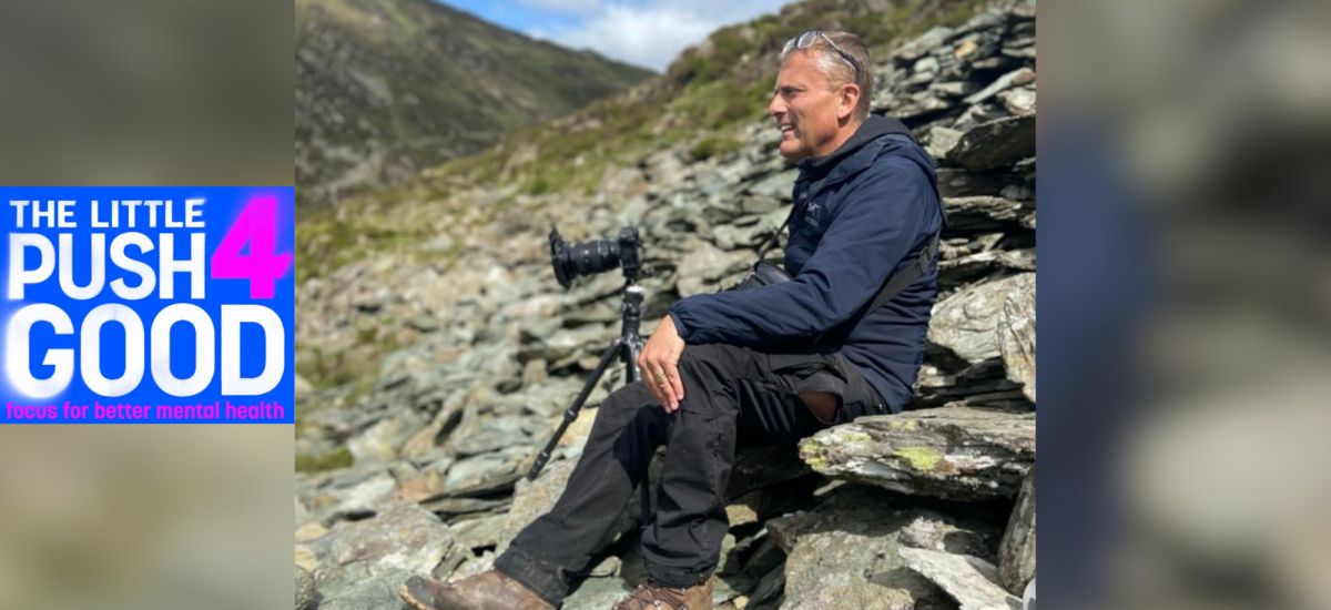 photo of a man sat outside with a camera