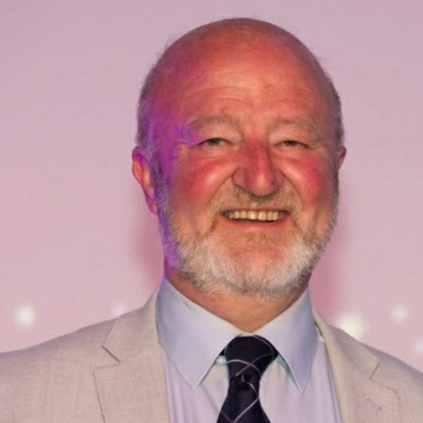 Smiling man in light suit jacket