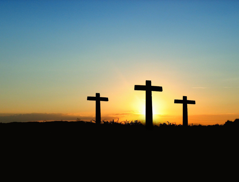 three crosses silhouetted in the sunset