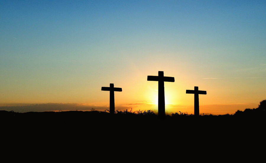 three crosses silhouetted in the sunset